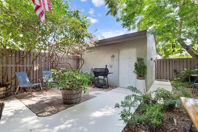 view of patio / terrace featuring a grill and fence