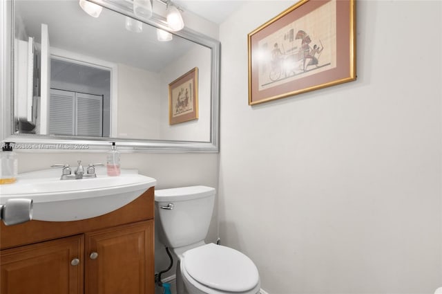 half bath featuring toilet and vanity