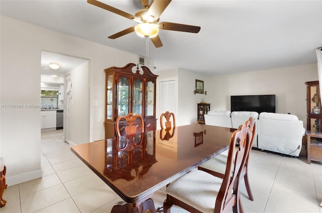 dining area with light tile patterned floors and a ceiling fan