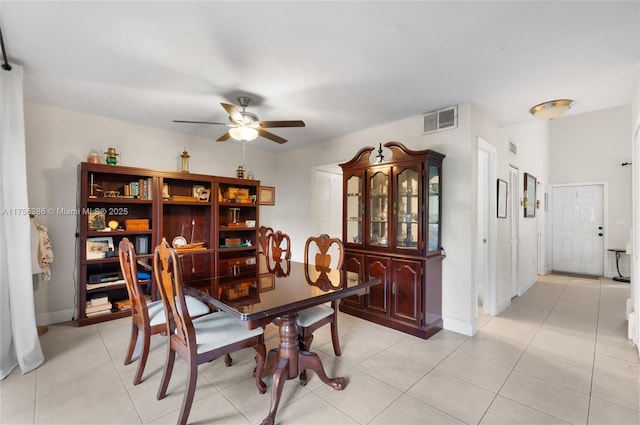 dining room featuring light tile patterned floors, ceiling fan, visible vents, and baseboards