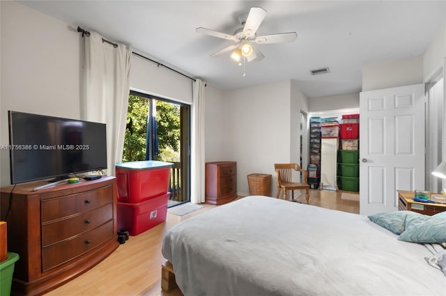 bedroom featuring access to outside, light wood-type flooring, visible vents, and a ceiling fan