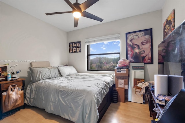 bedroom with light wood-style floors and a ceiling fan