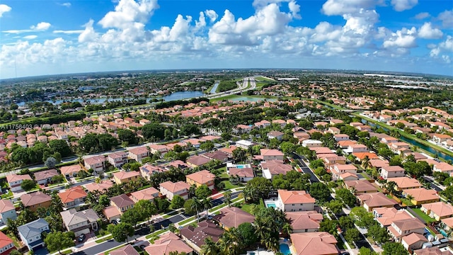 birds eye view of property featuring a water view and a residential view