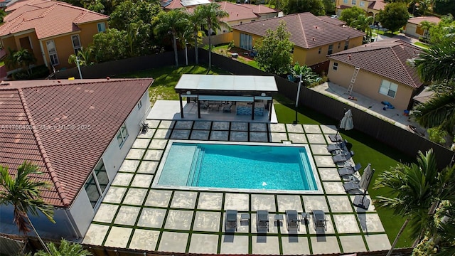 view of pool featuring a patio area, a fenced backyard, a residential view, and a fenced in pool