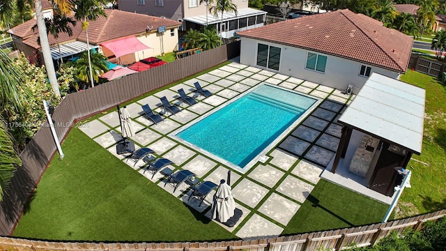 pool with a fenced backyard, a lawn, and a patio