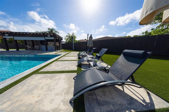 view of swimming pool with a yard, a patio area, a fenced backyard, and a fenced in pool