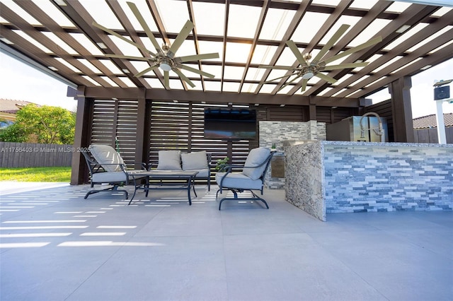 view of patio / terrace with ceiling fan, fence, and an outdoor living space