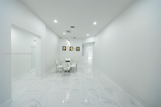 unfurnished dining area featuring recessed lighting, marble finish floor, visible vents, and baseboards