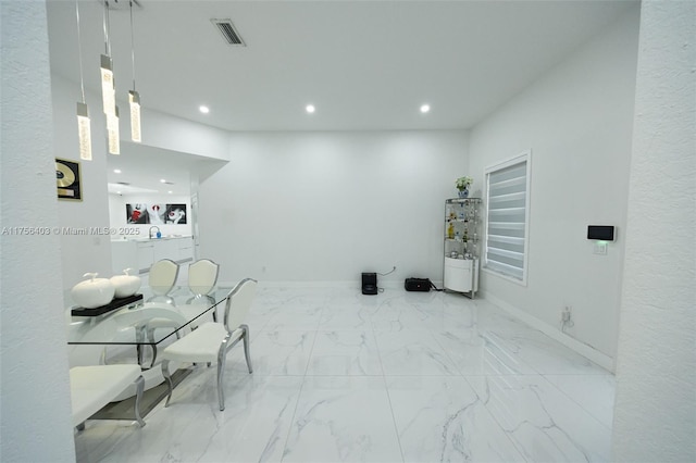 interior space with recessed lighting, marble finish floor, visible vents, and baseboards