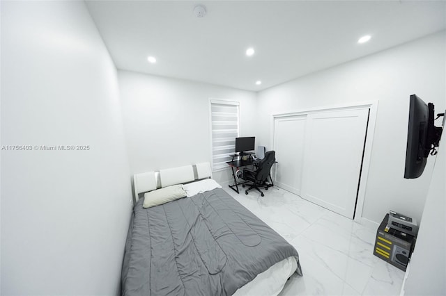 bedroom featuring marble finish floor, a closet, and recessed lighting