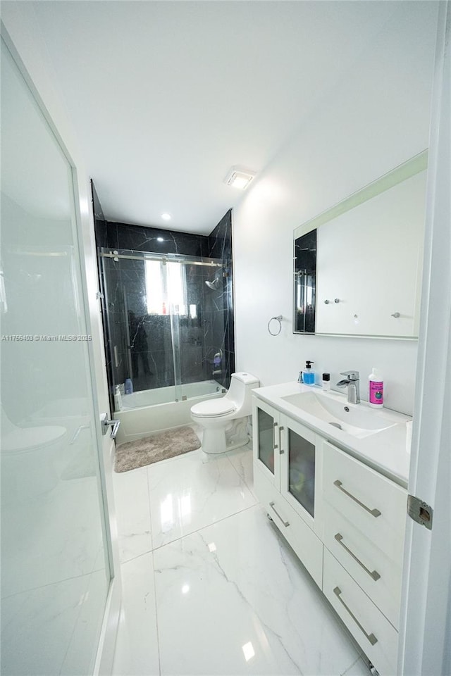 bathroom featuring marble finish floor, vanity, toilet, and bath / shower combo with glass door