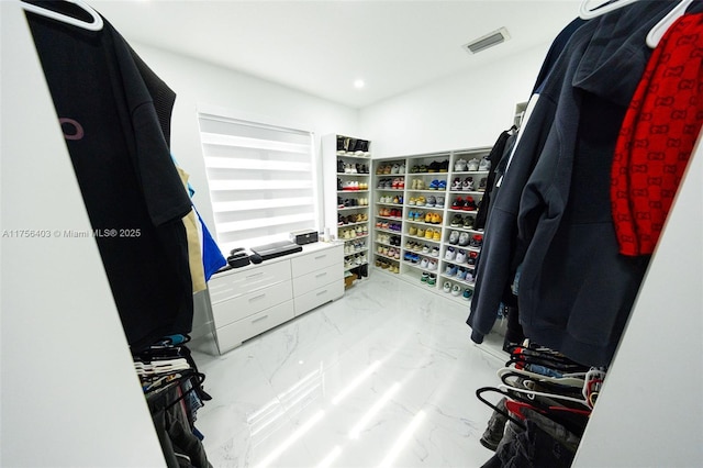 spacious closet featuring marble finish floor and visible vents