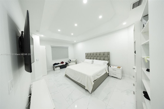 bedroom with marble finish floor, a tray ceiling, visible vents, and recessed lighting