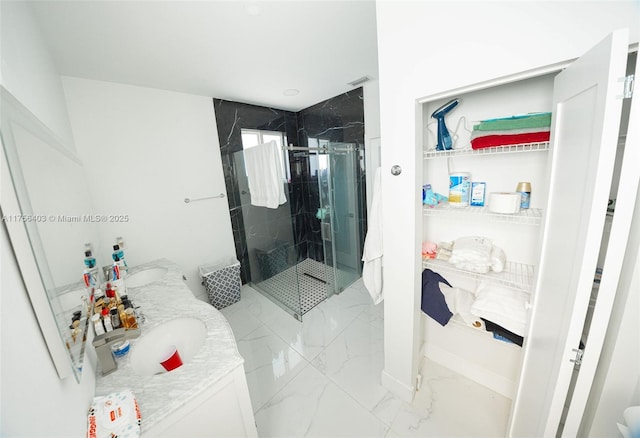 full bathroom featuring marble finish floor, a shower stall, and vanity