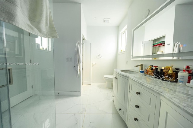 full bathroom with marble finish floor, plenty of natural light, vanity, and toilet