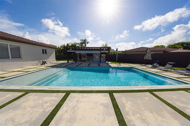 view of swimming pool with a patio, fence, a fenced in pool, and a pergola