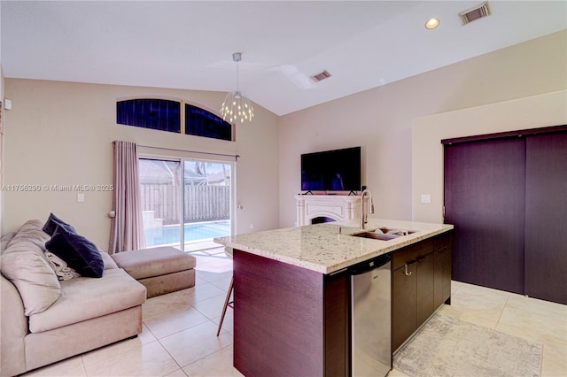 kitchen with open floor plan, visible vents, a sink, and stainless steel dishwasher