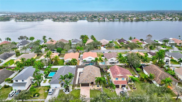 bird's eye view with a water view and a residential view