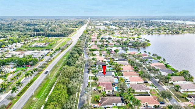 drone / aerial view with a water view and a residential view