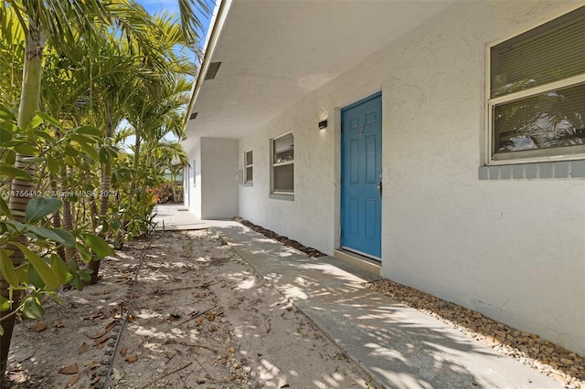 property entrance featuring stucco siding