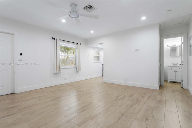 unfurnished bedroom featuring baseboards, visible vents, ensuite bath, light wood-type flooring, and recessed lighting