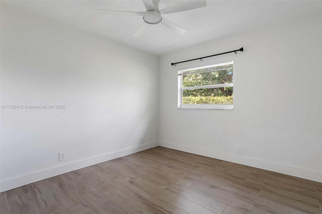 unfurnished room featuring a ceiling fan, baseboards, and wood finished floors