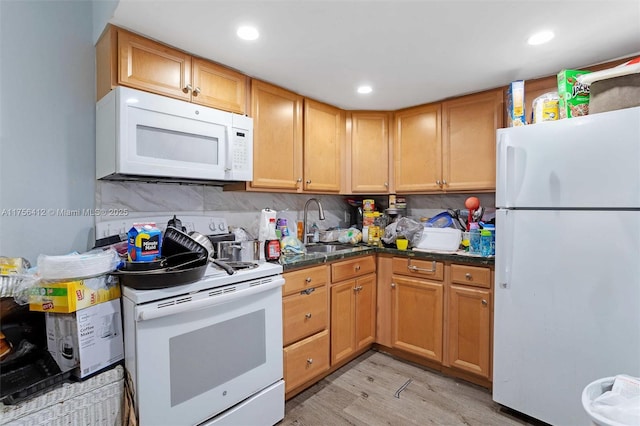 kitchen with recessed lighting, white appliances, a sink, light wood-style floors, and decorative backsplash