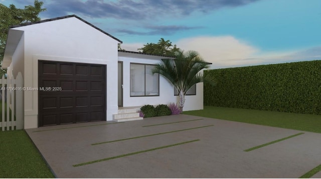 view of front of home with concrete driveway and stucco siding