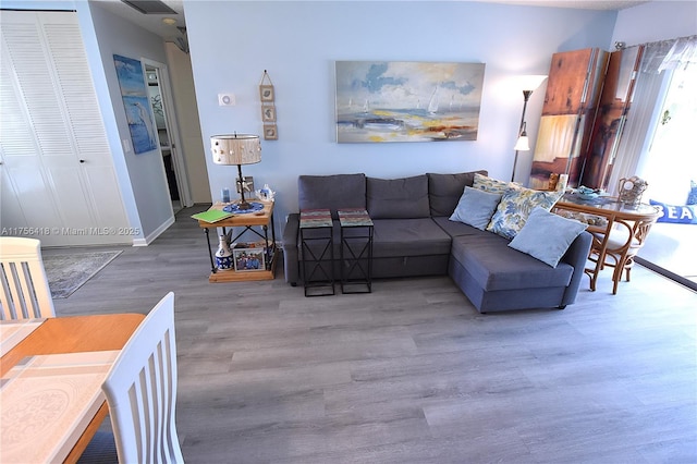 living area featuring baseboards and wood finished floors