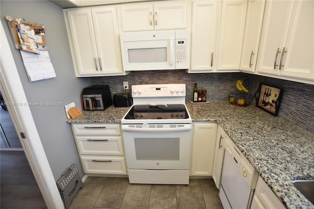 kitchen featuring white appliances, white cabinetry, light stone counters, and backsplash