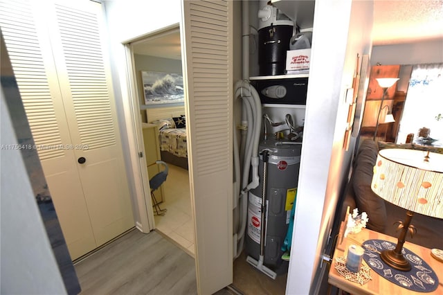 utility room featuring water heater