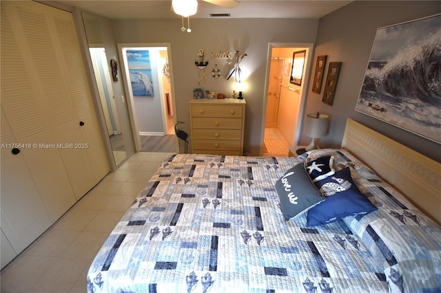 bedroom with light tile patterned floors, ceiling fan, ensuite bathroom, visible vents, and a closet