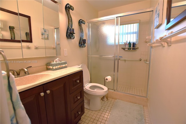 full bath featuring toilet, a stall shower, and vanity