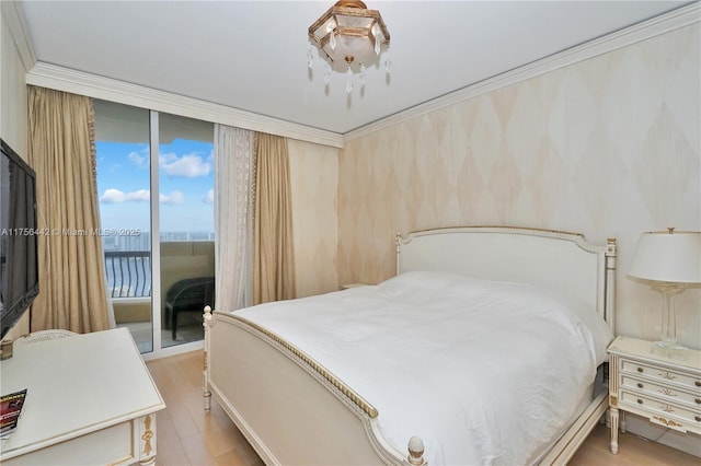 bedroom featuring light wood-type flooring, access to outside, floor to ceiling windows, and ornamental molding