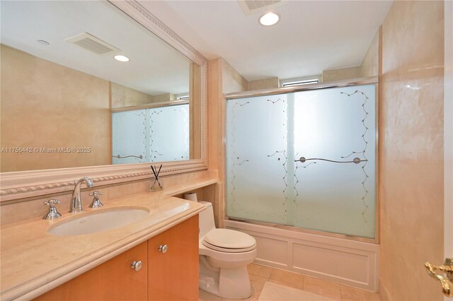 bathroom with visible vents, toilet, tile patterned floors, vanity, and recessed lighting