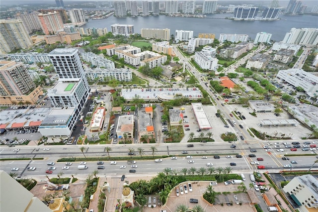 birds eye view of property featuring a water view and a city view