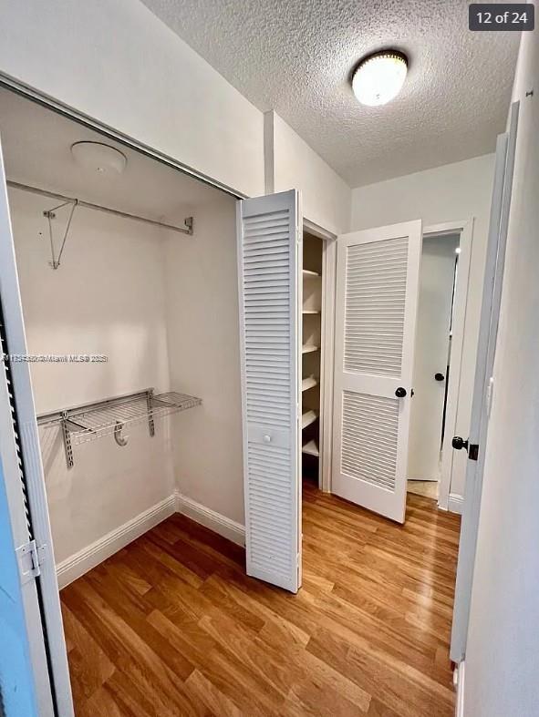 spacious closet with wood finished floors