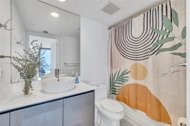 bathroom featuring toilet, shower / bath combo with shower curtain, vanity, and visible vents