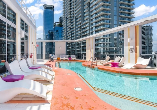 view of pool featuring a view of city and a patio area