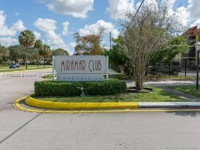 community sign featuring fence