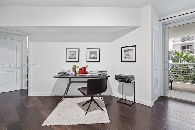 office space with baseboards and dark wood finished floors