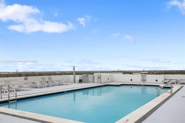 community pool featuring a patio area and fence