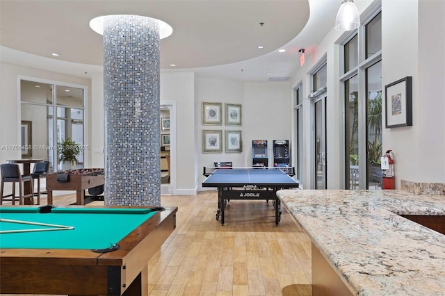 rec room with recessed lighting, decorative columns, and light wood-style flooring