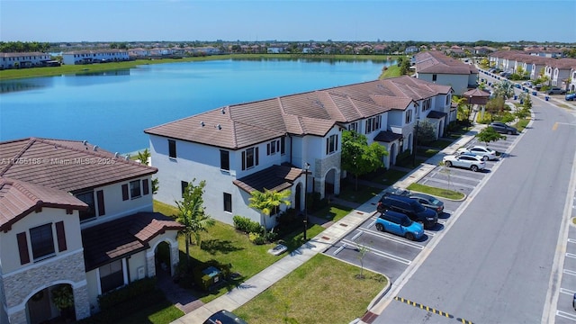 drone / aerial view featuring a water view and a residential view