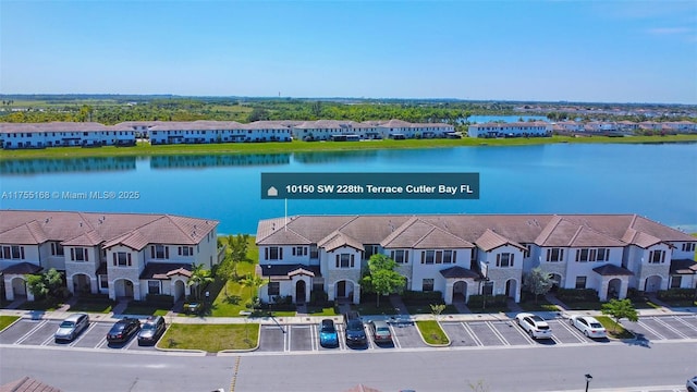 drone / aerial view with a residential view and a water view