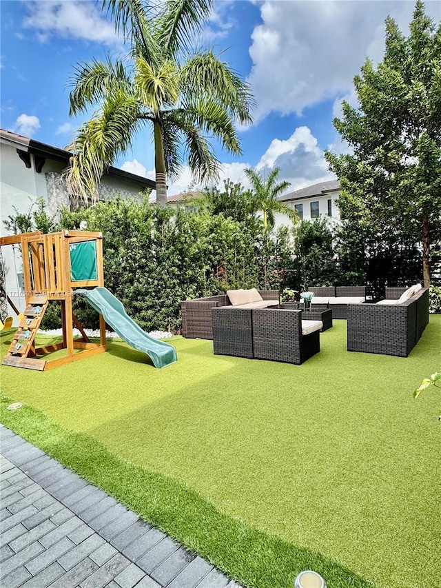 view of play area featuring an outdoor hangout area and a yard