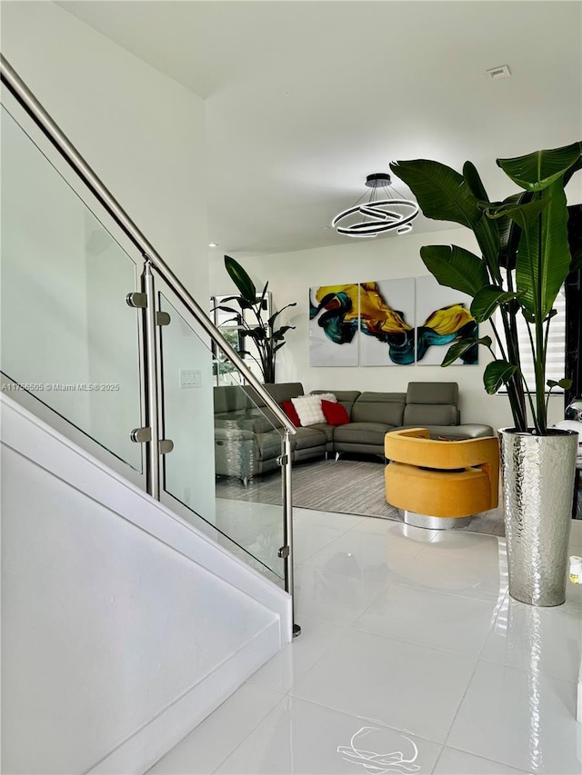 hallway with stairs and tile patterned flooring