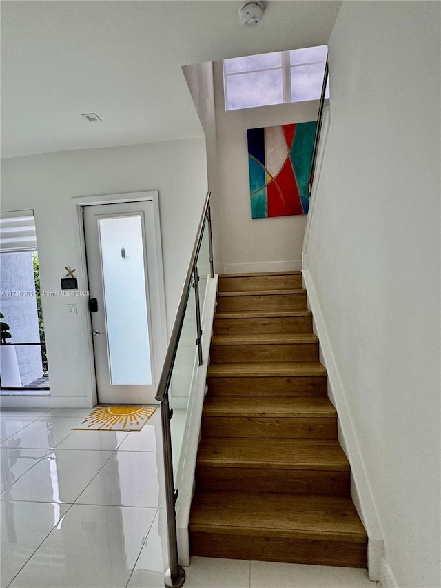 staircase featuring baseboards