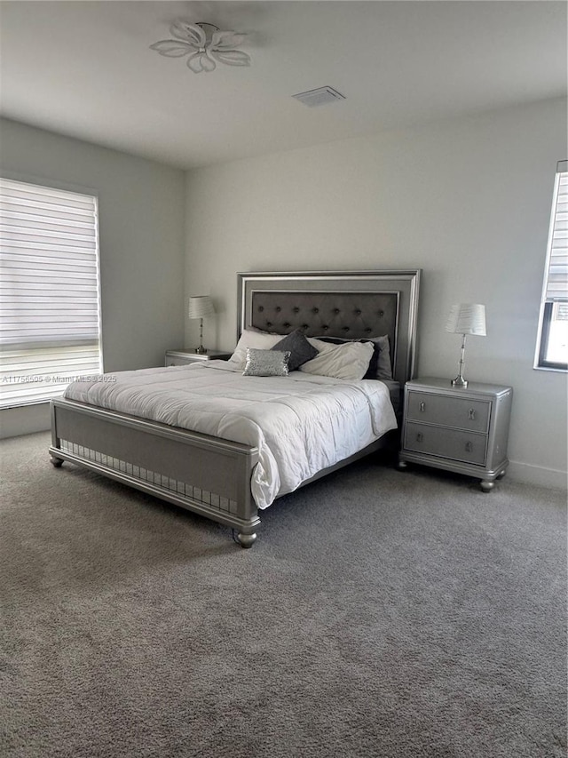 bedroom featuring carpet floors and visible vents