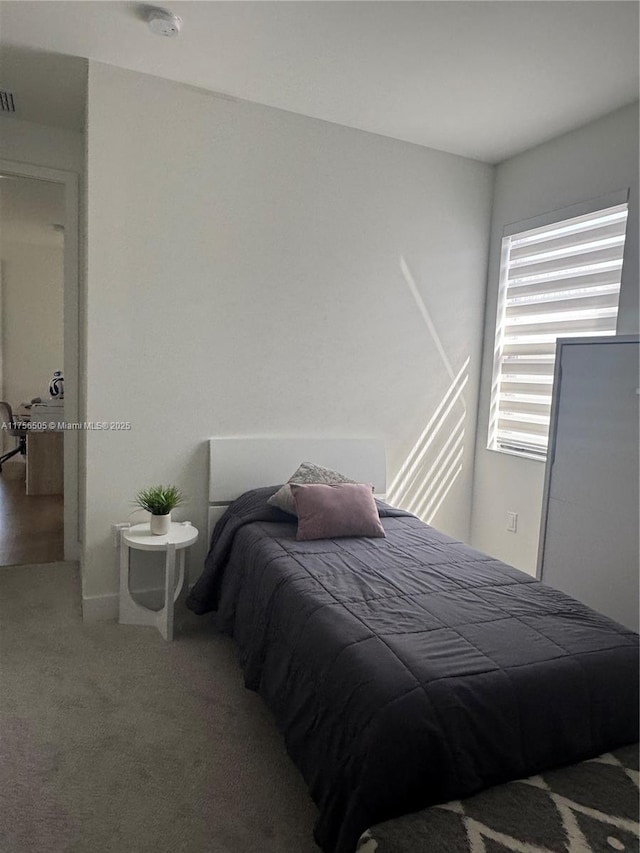 carpeted bedroom with visible vents